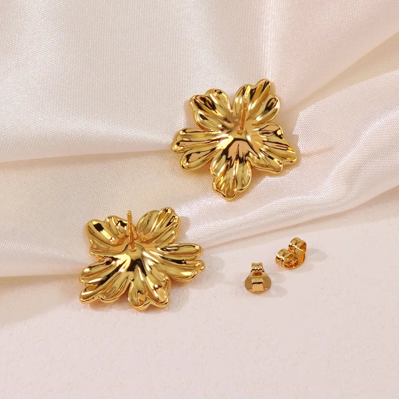 Gold Flower Stud Earrings by Zivnaaz